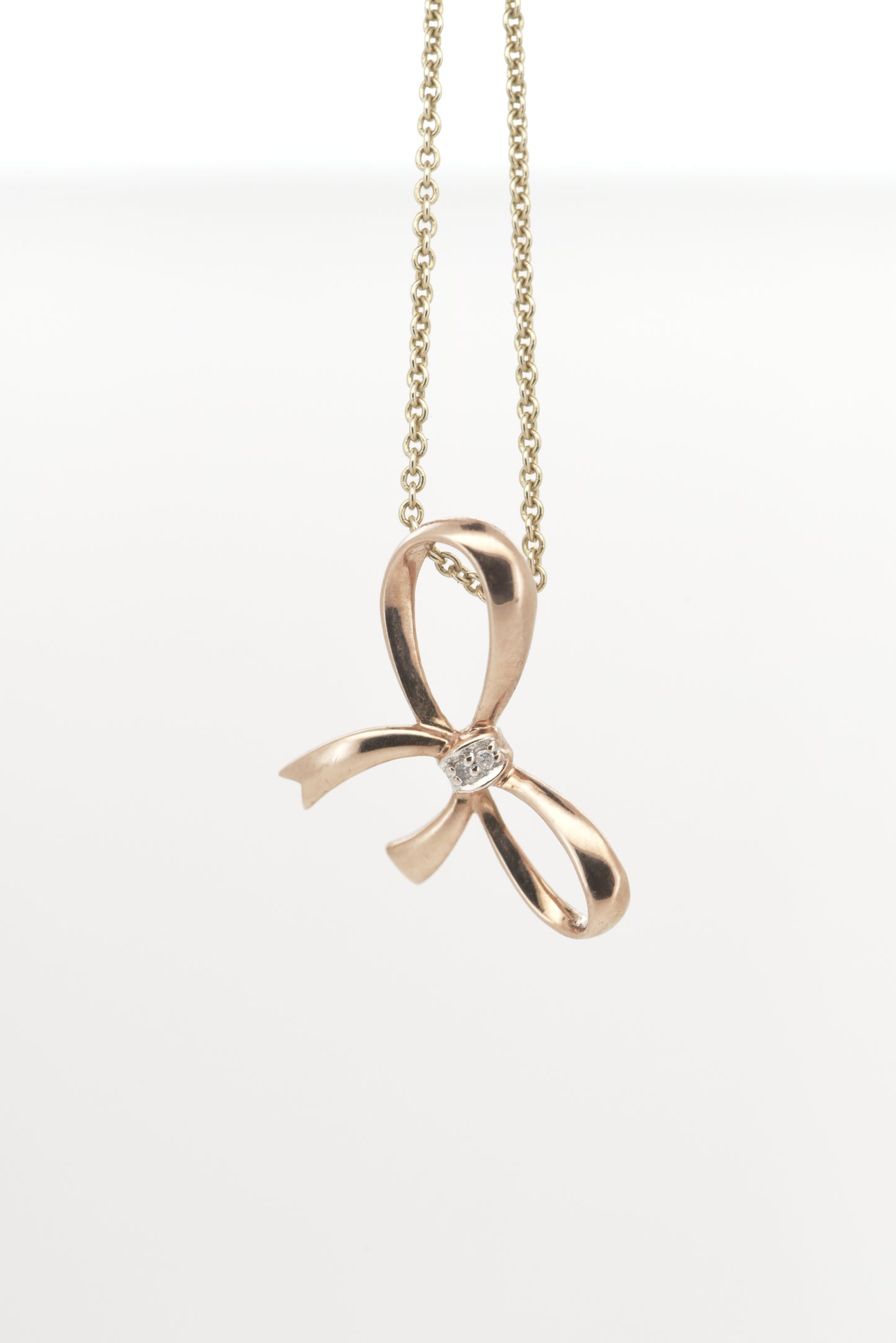 Rose gold bow pendant with tiny diamond accent 9ct rose gold