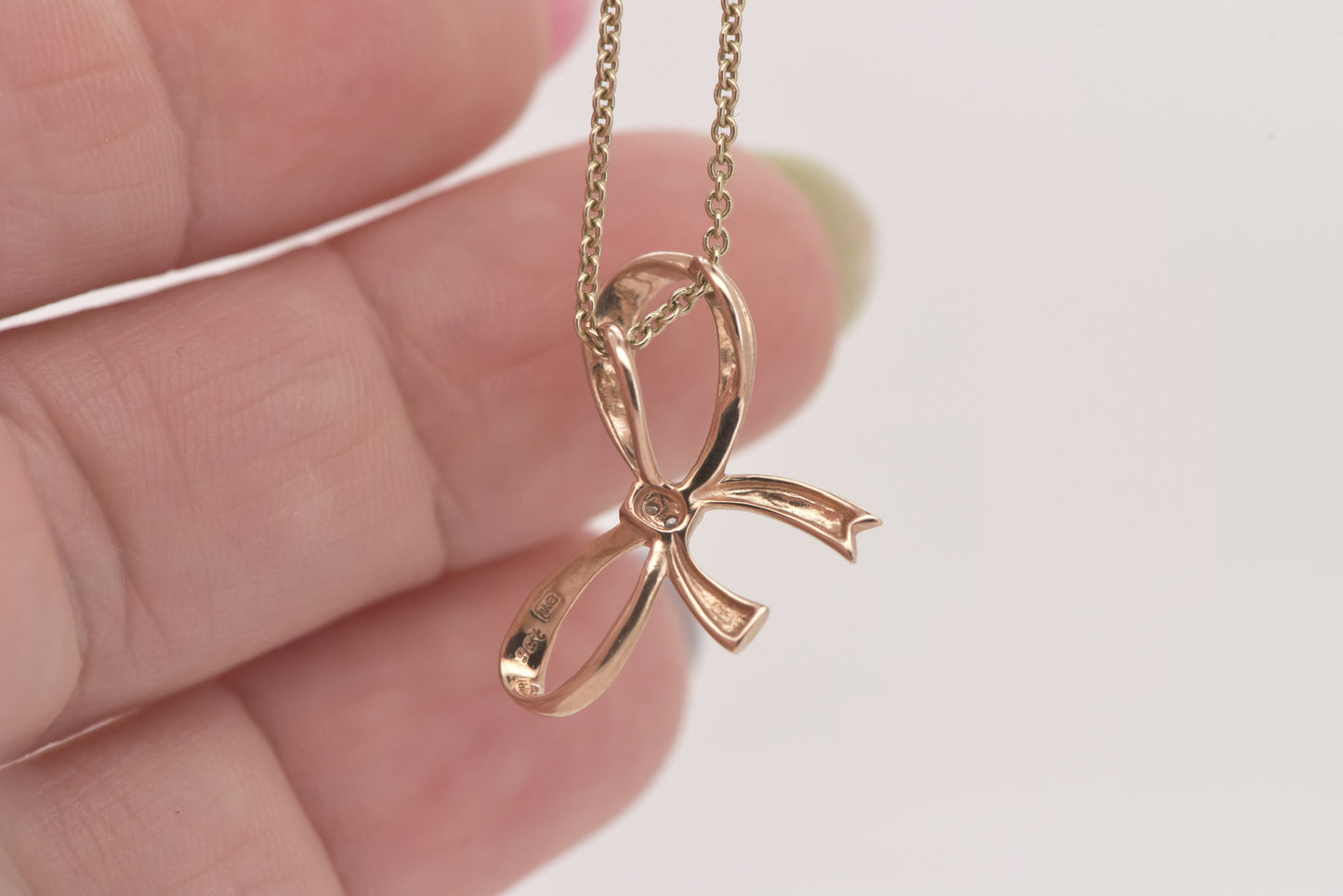 Rose gold bow pendant with tiny diamond accent 9ct rose gold