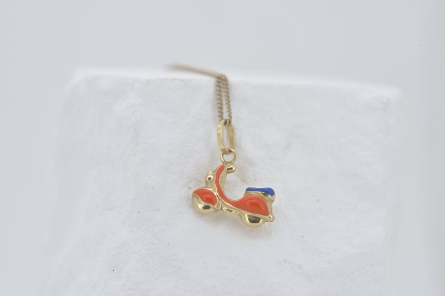 Vespa charm in 9ct yellow gold with orange and blue enamel