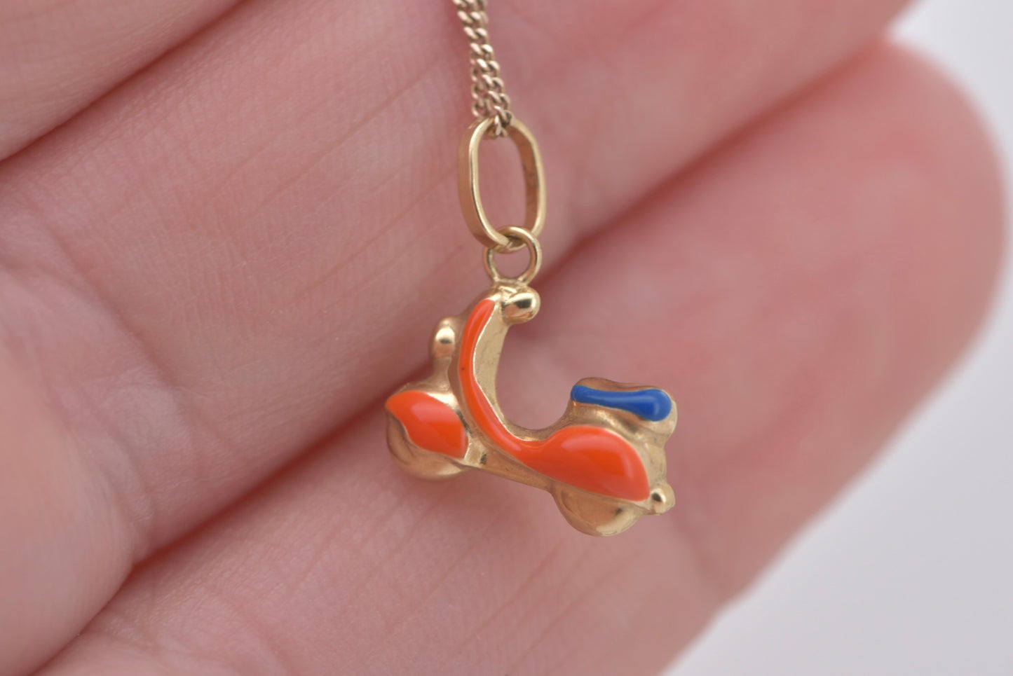 Vespa charm in 9ct yellow gold with orange and blue enamel