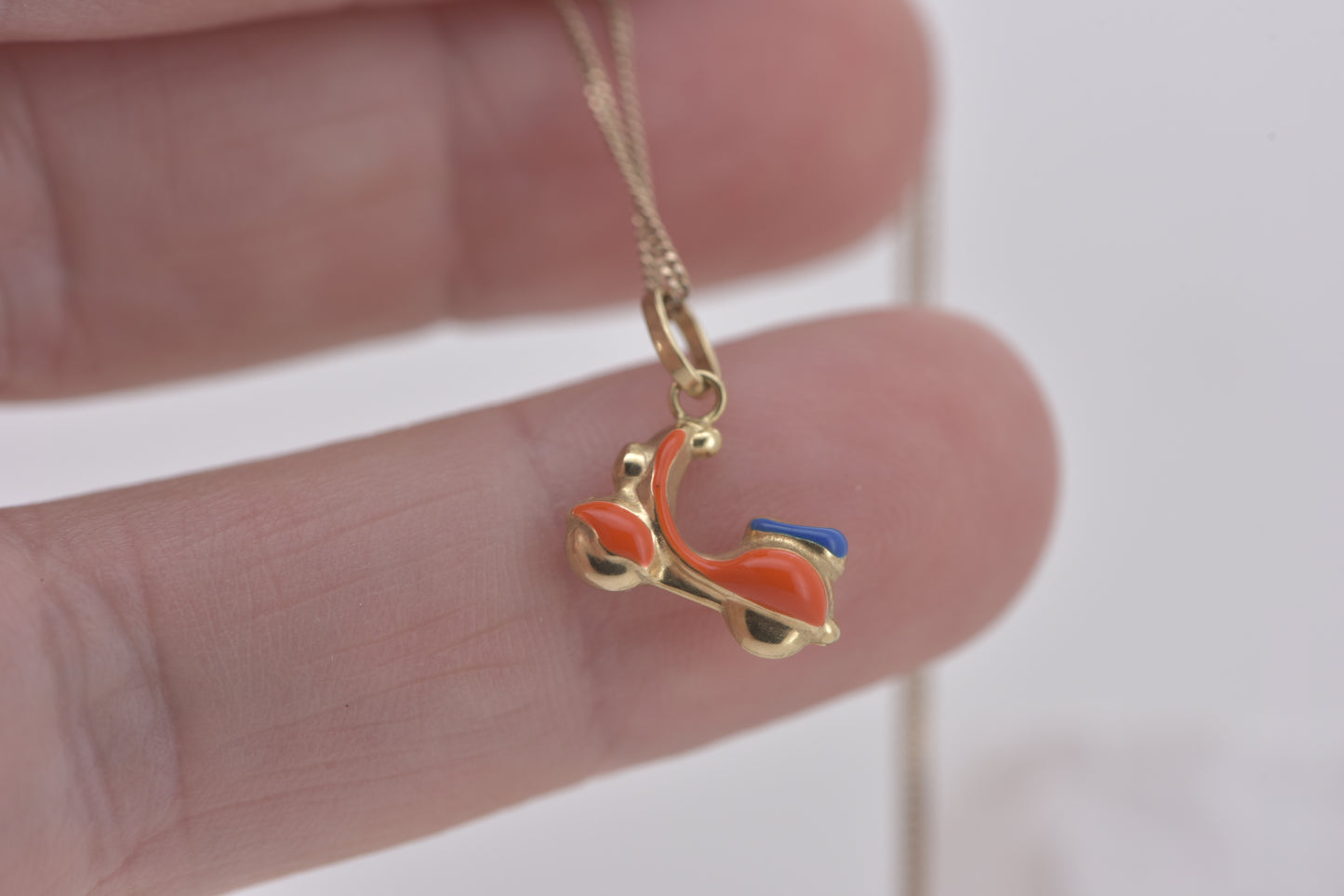 Vespa charm in 9ct yellow gold with orange and blue enamel